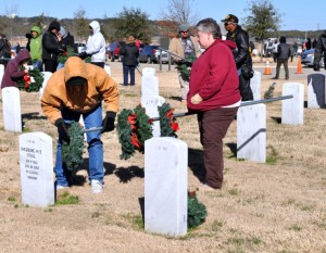 Bryan Correira | Herald Two volunteers remove a wreath from a grave at the Central Texas State Veterans Cemetery on Sunday, Jan. 5, 2014.