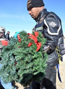 Bryan Correira | Herald Sgt. Secoya Allen with the 4th Sustainment Brigade, 13th Sustainment Command, removes a wreath from a grave at the Central Texas State Veterans Cemetery on Sunday, Jan. 5, 2014.